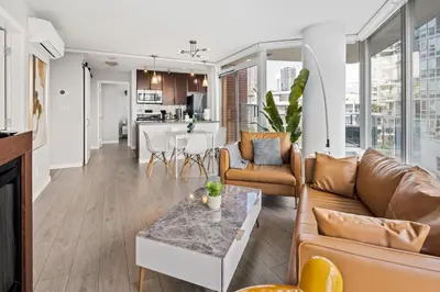 a living room with a couch and a table at GardenView Modern Condo with Parking, Gym, Pool, AC in Vancouver
