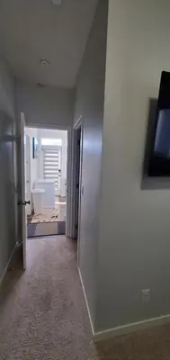 an empty room with a hallway leading to a bathroom at Delightful 1-bedroom Private Suite in a New Home in Calgary
