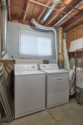 a laundry room with two washers and a window at 2bedroom suite w/ great access into & out the city - 7818 in Calgary
