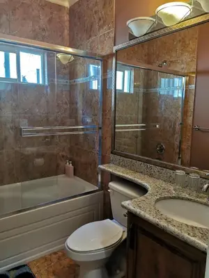 a bathroom with a toilet and a sink and a shower at Nini Sweet home in Richmond