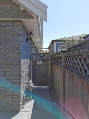 a fire hydrant in front of a house with a fence at Nini Sweet home in Richmond