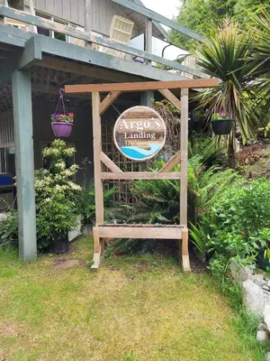 a sign in front of a house with a sign at Argo's Landing in Bamfield