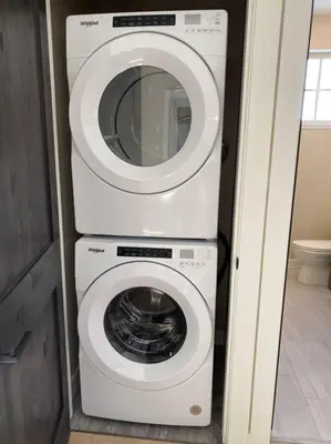a washing machine and a dryer in a bathroom at Cozy Modern Ski-in & Ski-out, Hot Tub, Townhouse in Sun Peaks
