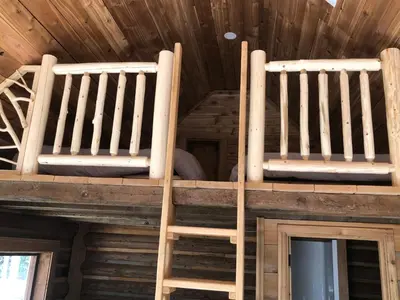 two wooden bunk beds on the ceiling of a cabin at Mini Moo-light Cabin in Clearwater