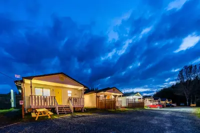 a row of houses on a street under a cloudy sky at The Cabins at Alert Bay in Alert Bay