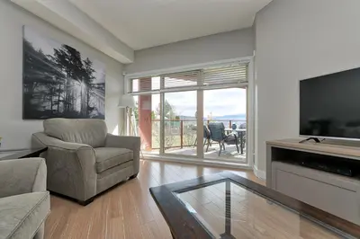 a living room with a tv and a couch and a chair at Stay In The Okanagan - Copper Sky, West Kelowna in West Kelowna