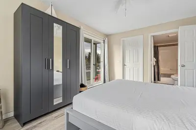 a bedroom with a large bed and a window at Polar Peaks Hot Tub Pool Gas Fireplace in Radium Hot Springs