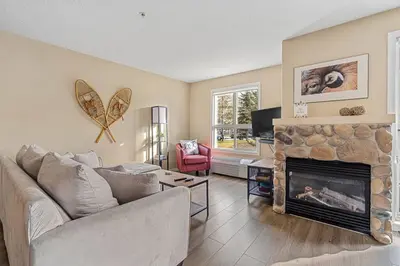 a living room with a couch and a fireplace at Polar Peaks Hot Tub Pool Gas Fireplace in Radium Hot Springs
