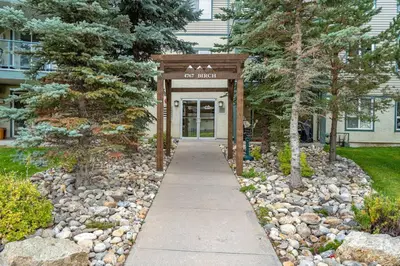 a walkway leading to the entrance to a building at Polar Peaks Hot Tub Pool Gas Fireplace in Radium Hot Springs