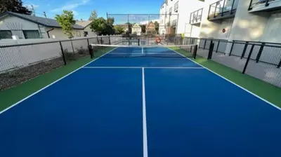 a blue tennis court in a house at Top Floor Lakeshore Views Near Skiing in Vernon