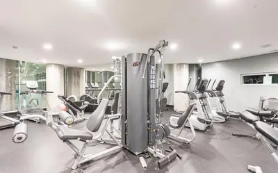 a gym with a bunch of treadmills and machines at Vancouver Nest Downtown 2BR near Rogers Arena in Vancouver