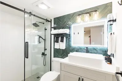 a bathroom with a shower and a sink and a toilet at Vancouver Nest Downtown 2BR near Rogers Arena in Vancouver
