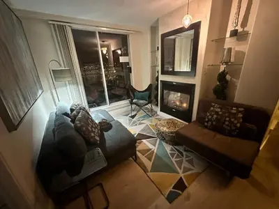 a living room with a couch and a fireplace at Penthouses of Beach Ave in Vancouver