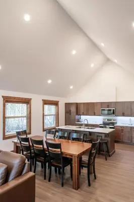 a kitchen with a table and chairs in a room at The Evergreen Cabin in Valemount