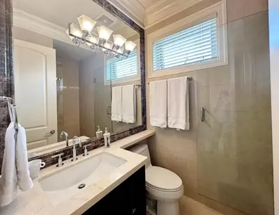 a bathroom with a sink and a toilet and a mirror at Campus Haven in Vancouver