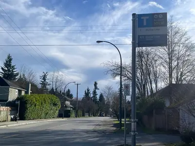 a street sign on the side of a road at Campus Haven in Vancouver